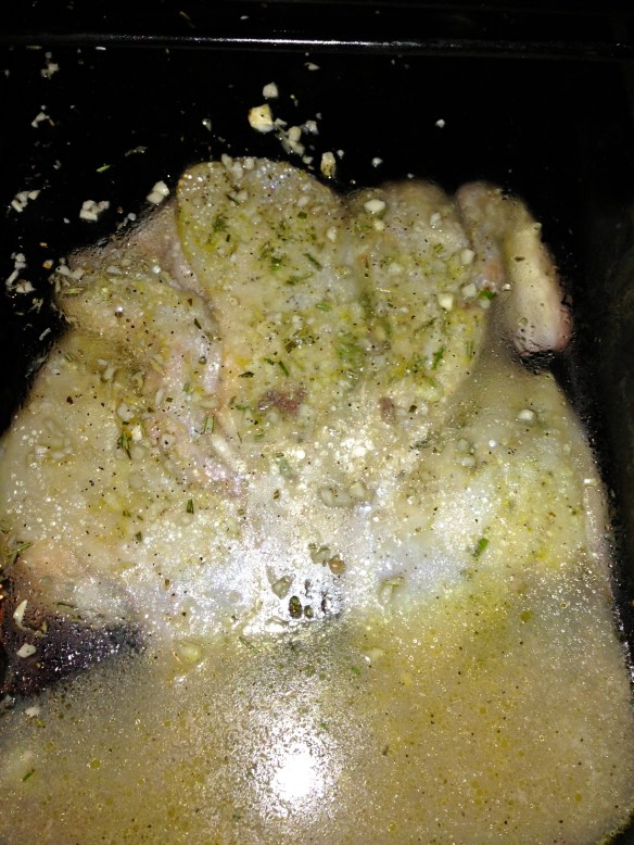 weighted down flattened chicken on grill